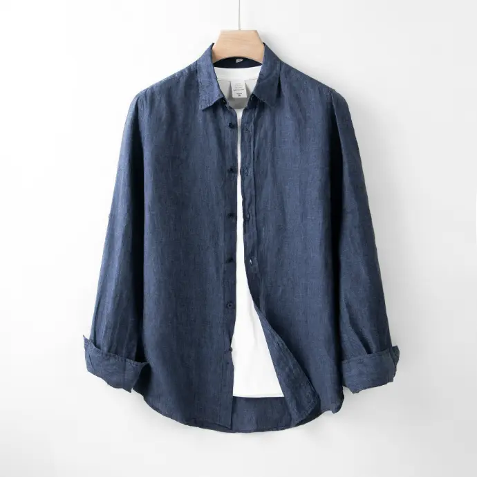 A blue shirt hanging on a white wall